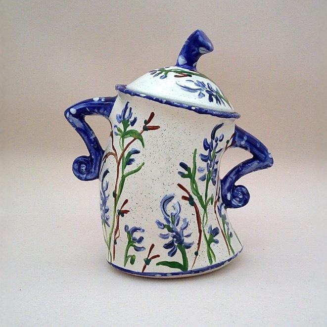 Decorative resin lidded jar, cream with blue floral pattern and navy handles