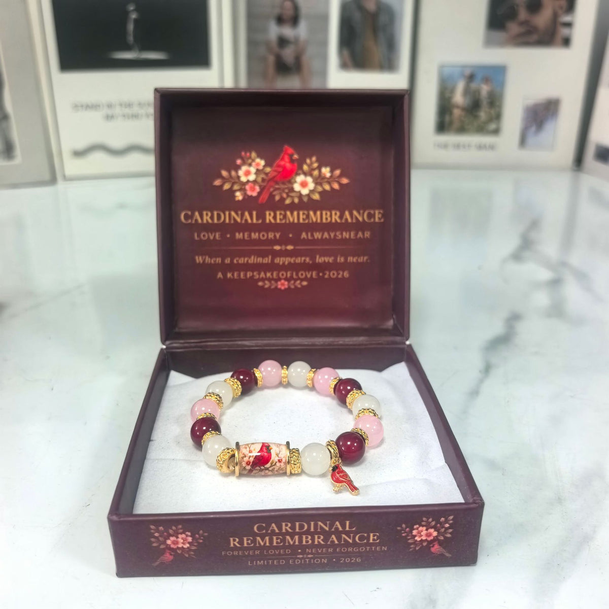 Beaded lucky bracelet with pink, gold, and purple beads plus a small red cardinal charm