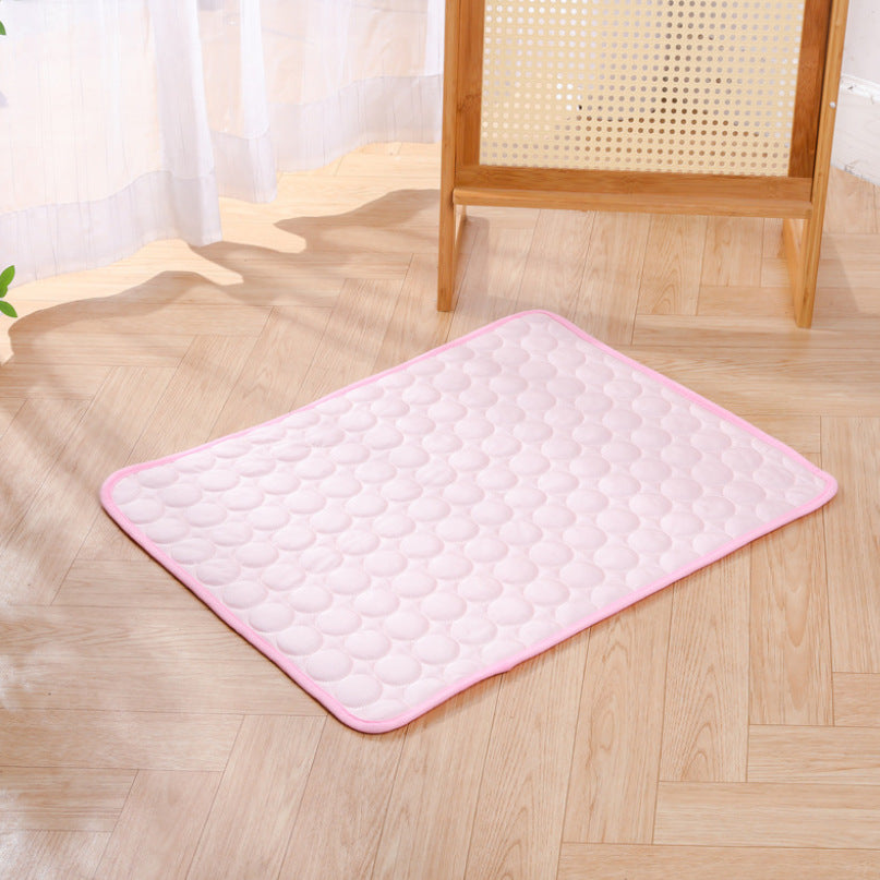 Pink ice silk cooling mat with raised pebble texture and soft edge binding