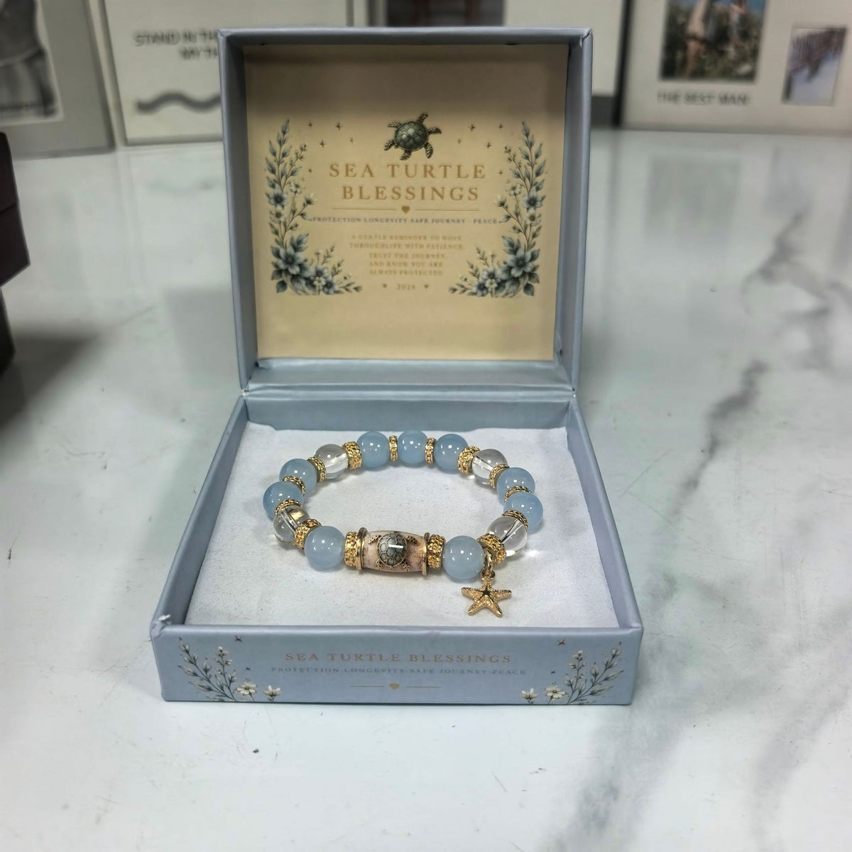 Sea turtle beaded elastic bracelet with light blue beads, gold spacers, turtle and star charms