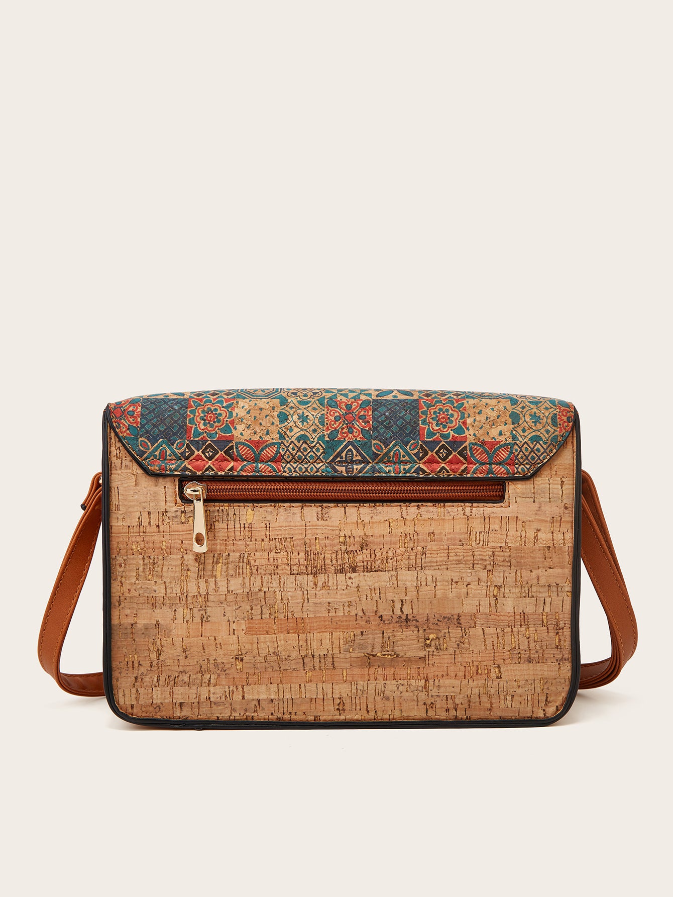 Women’s crossbody bag with teal printed flap, cork-style front panel, and brown straps
