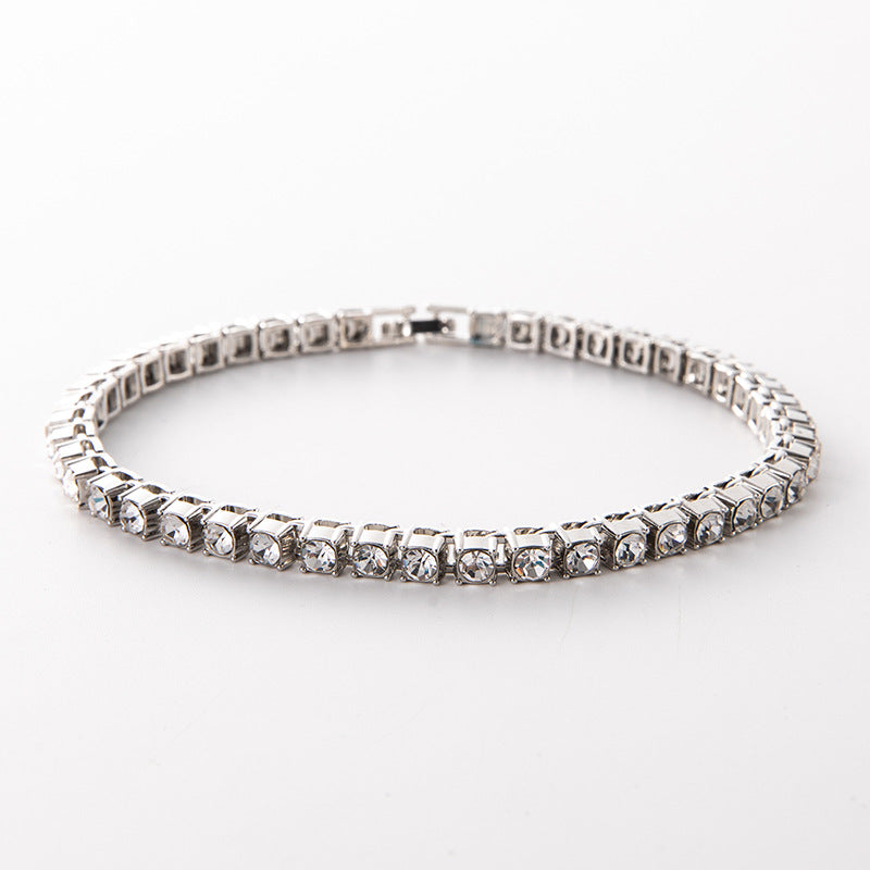 Silver diamond-cut tennis link bracelet with clear stones and clasp detail