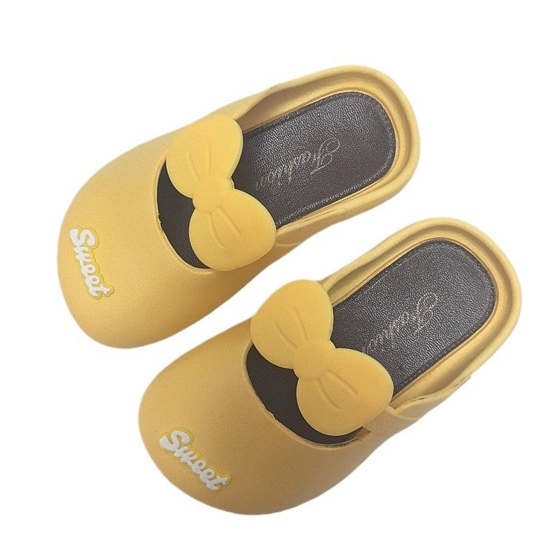 Yellow bow indoor slipper with black accent trim and soft cushioned insole