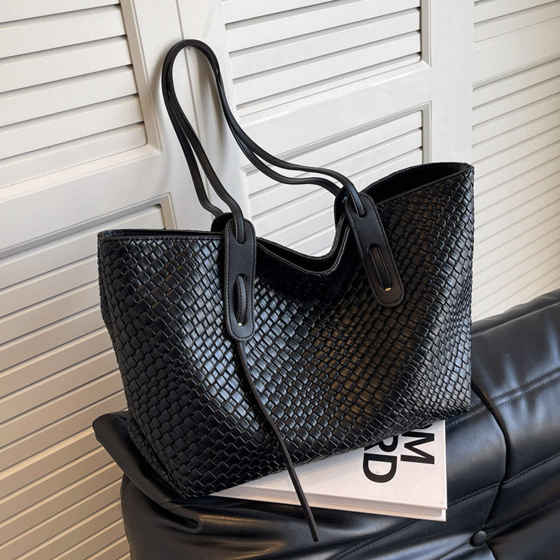 Woven PU tote bag in black with two short handles and long shoulder strap