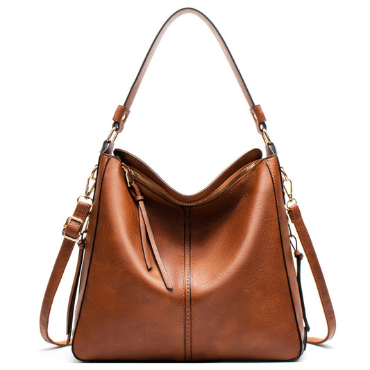 Brown PU leather shoulder crossbody bag with wide opening and interior zip pocket