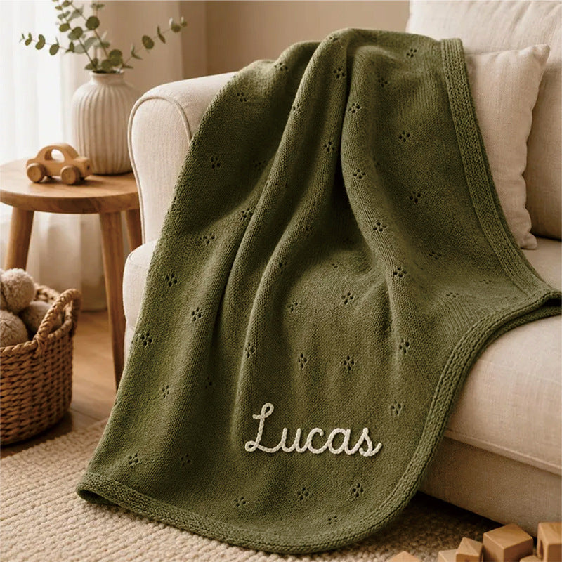 Olive green cotton baby blanket with small hollow floral embroidery and custom name "Lucas"