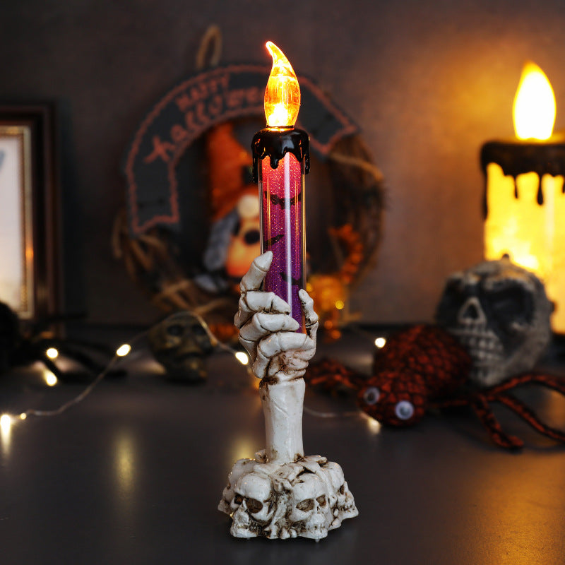 LED ghost hand candle with skull base, purple glow flame and white ghost hand