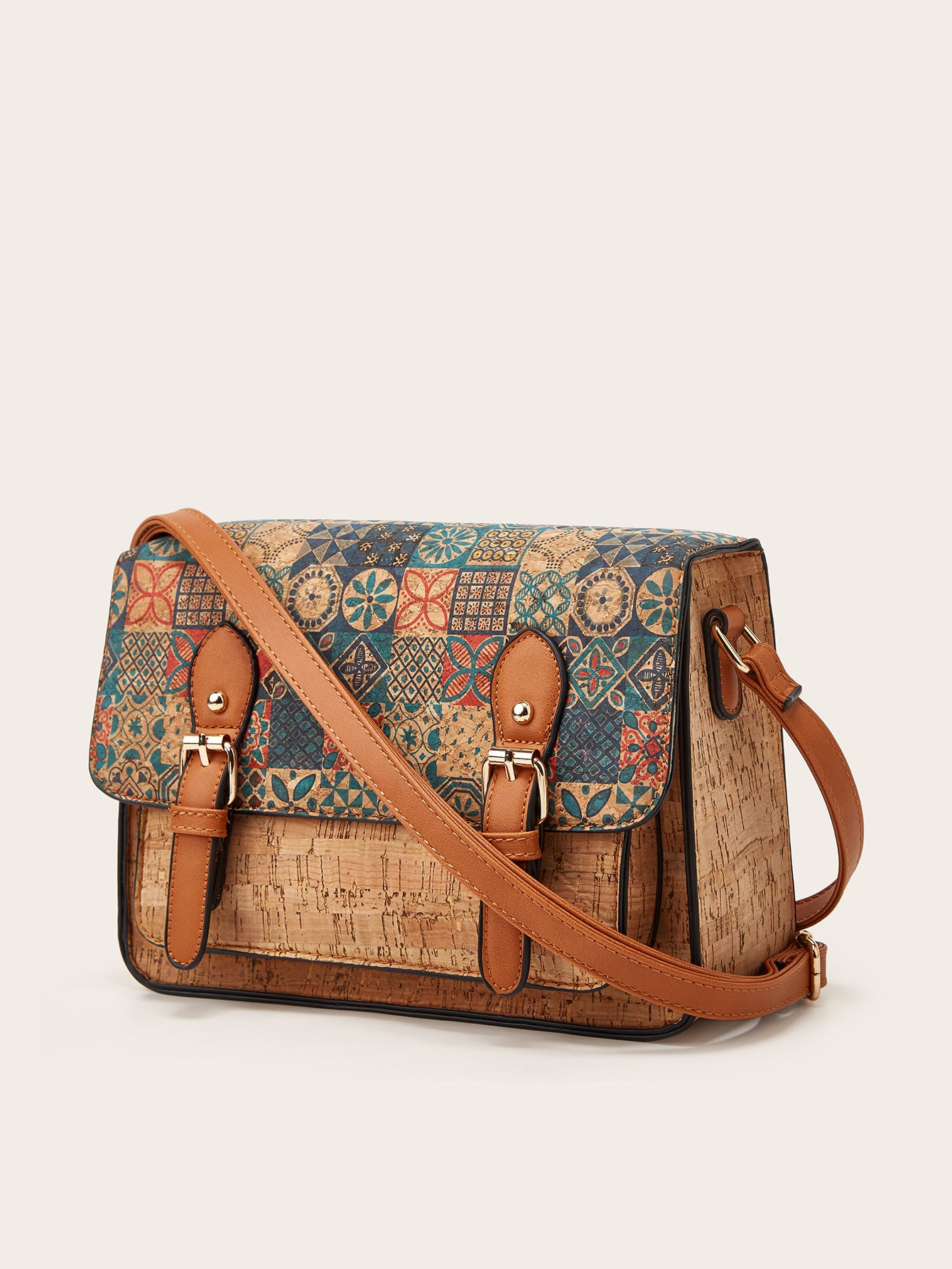 Women’s crossbody bag with teal-and-brown patterned flap and brown shoulder strap
