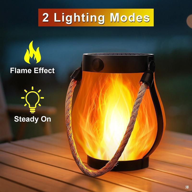 Solar flame-effect lantern with black body and orange flickering LED glow, hanging hemp rope