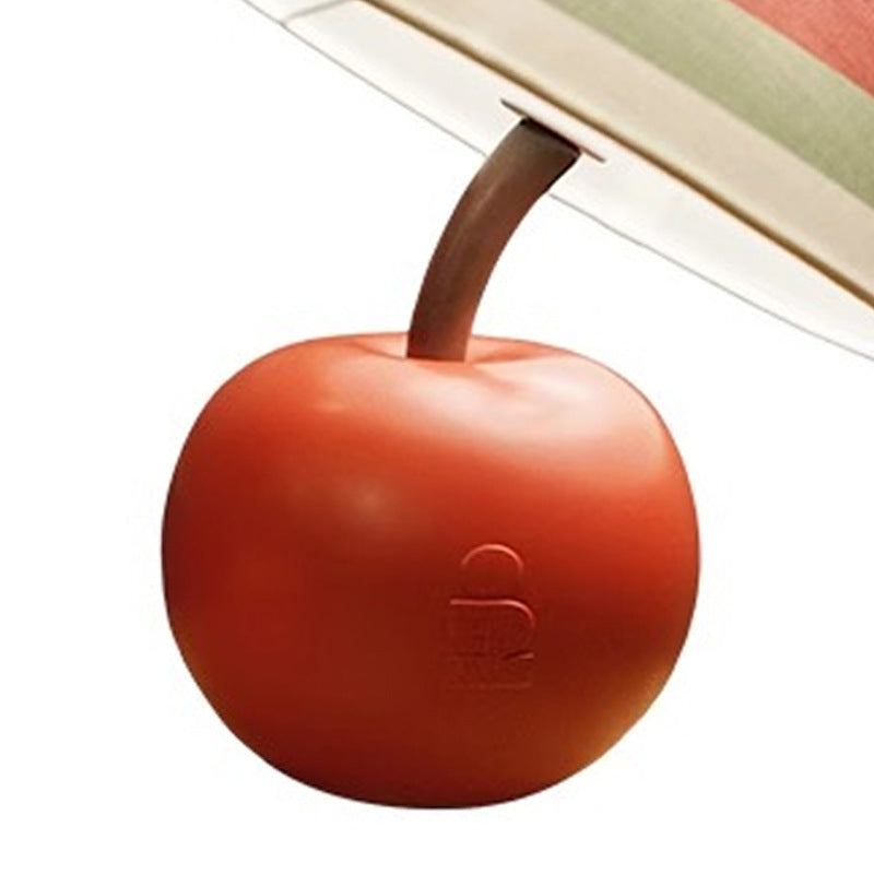 Close-up of apple-shaped lamp base and underside of striped lampshade.