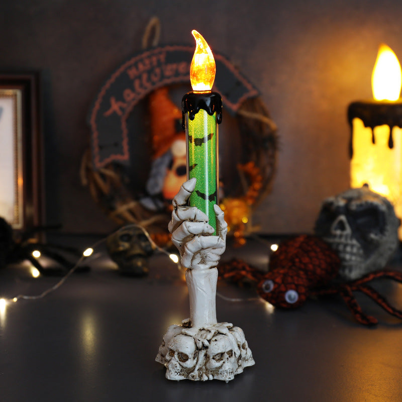 LED ghost hand candle with skull base, green glow flame and white ghost hand