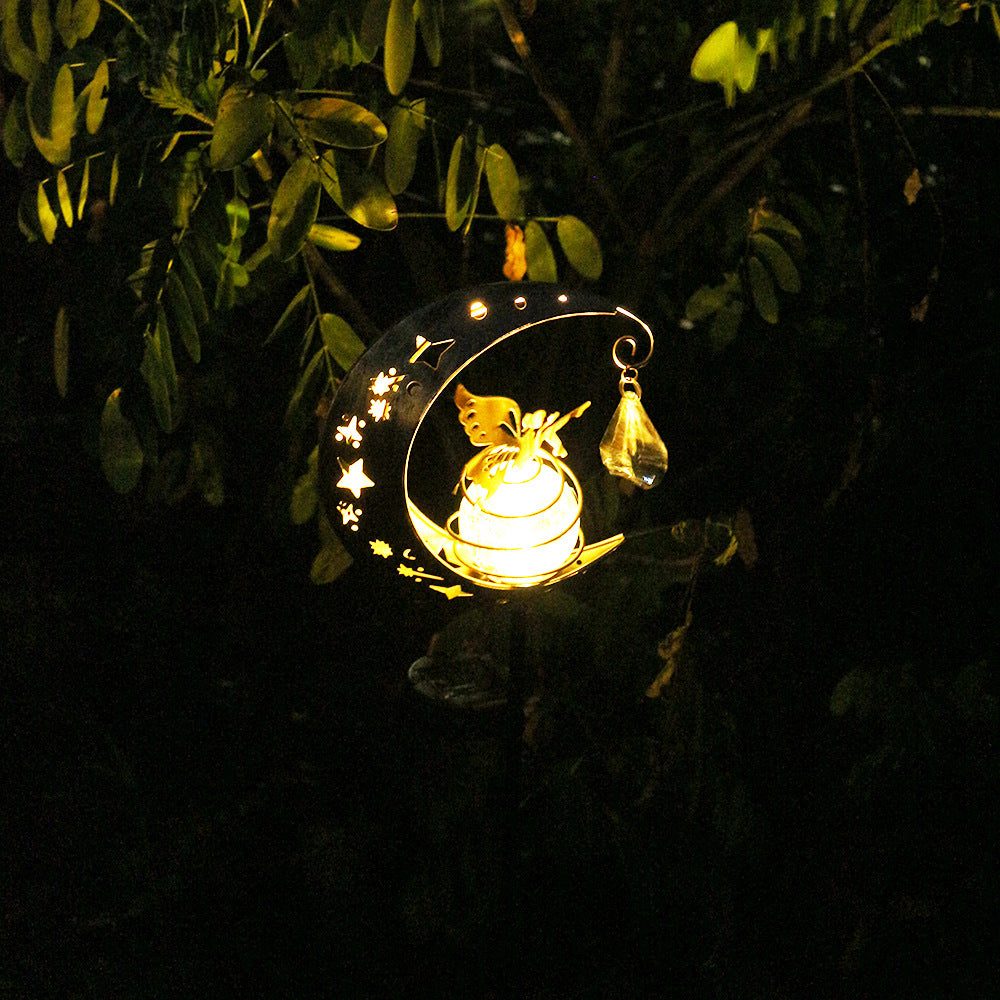Outdoor solar moon lamp with glowing gold butterfly fairy and hanging raindrop accents