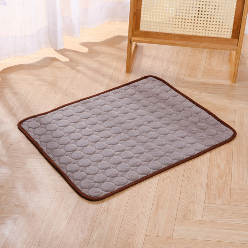 Gray ice silk cooling mat with raised pebble texture and brown edge trim