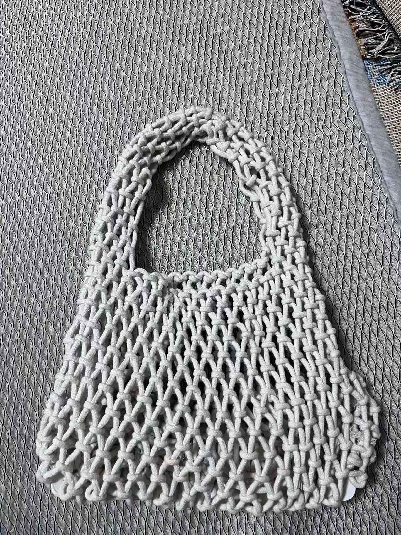 White crochet bucket bag with hollow net texture and looped rope handle
