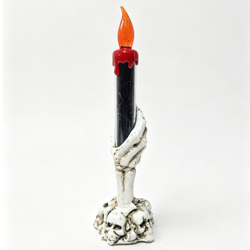 LED ghost hand candle with skull base, red drip candle and orange flickering flame