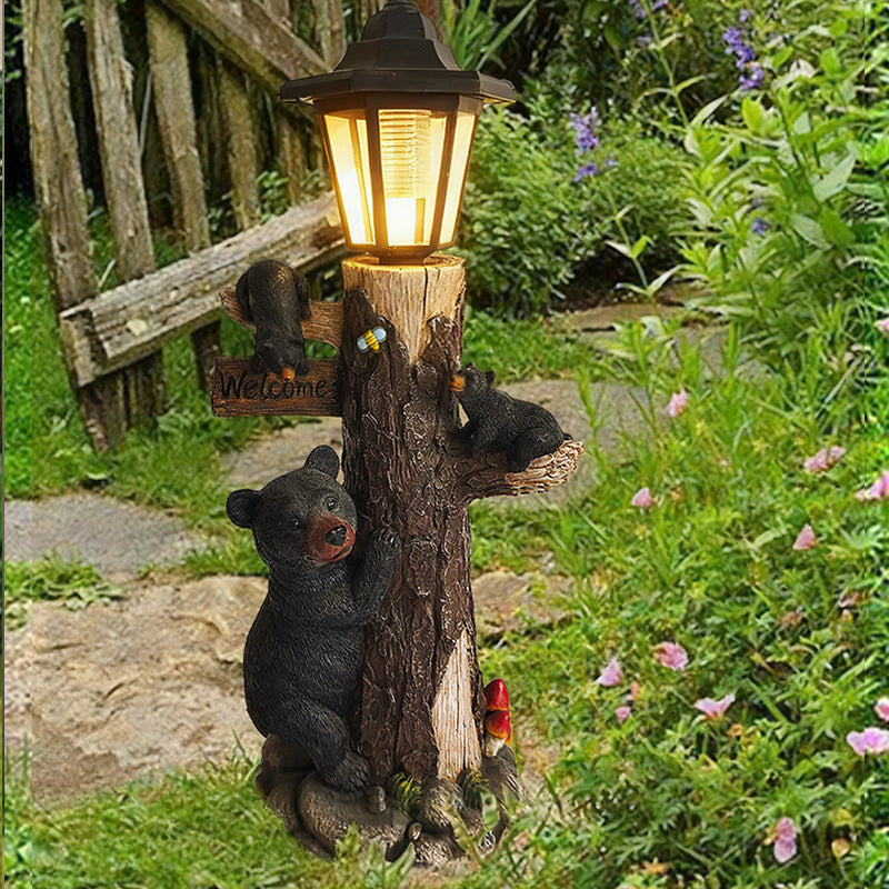 Solar garden light ornament: lantern on log with two black koalas and small yard decor