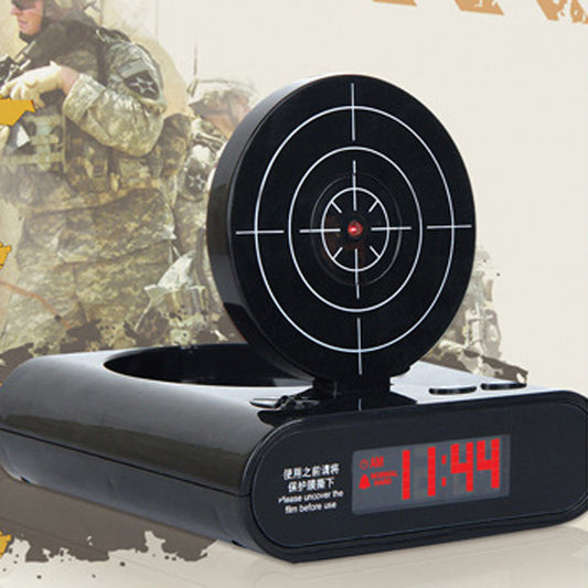 Black target alarm clock on its base with circular aiming dial and red LED time digits 11:44.