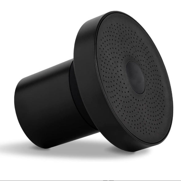 Black shower head with textured spray faceplate and shower arm connection