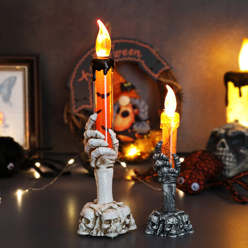 LED ghost hand candle with skull base and orange flickering flame