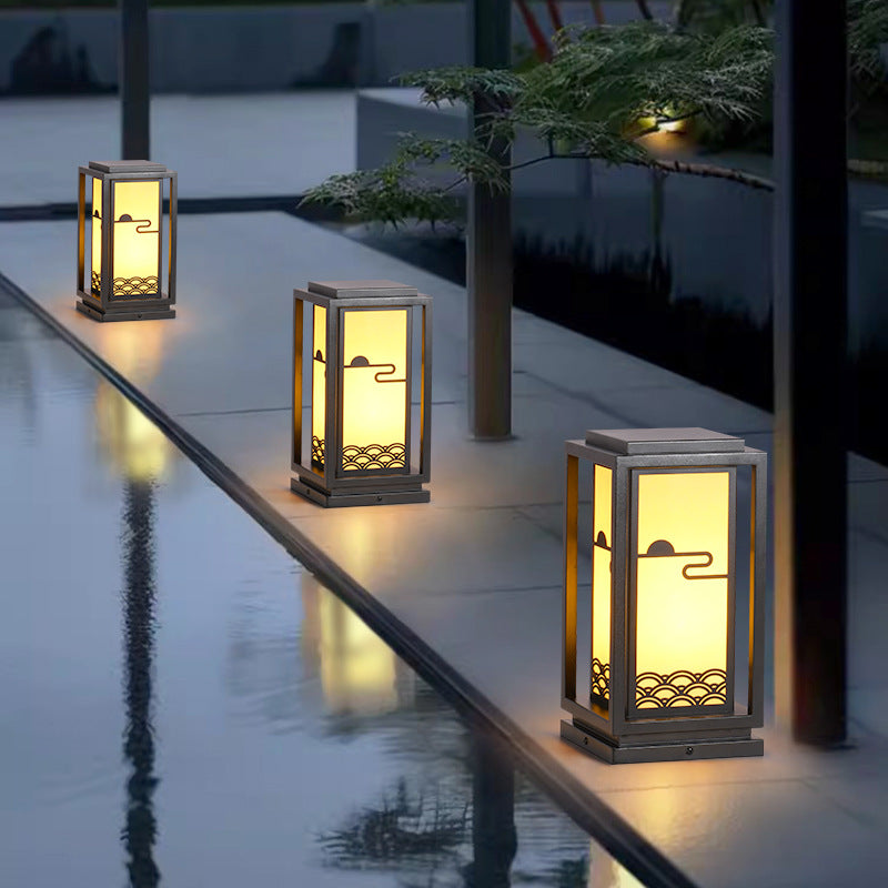 Rectangular solar lantern light with black frame, warm glow through frosted panels