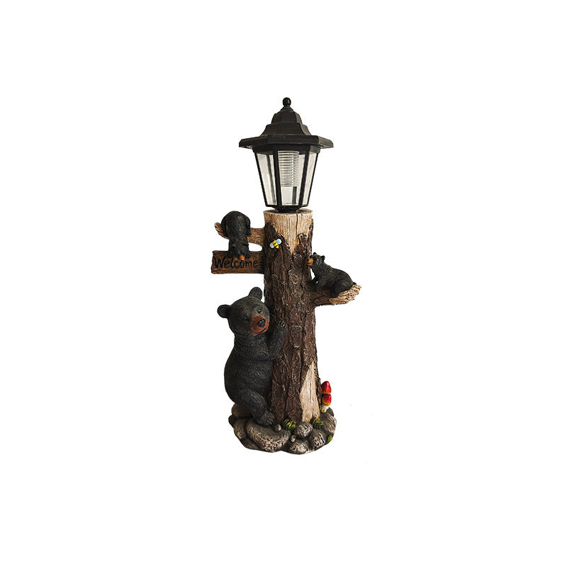 Solar garden light ornament with lantern on wooden log and hugging black koalas, full view