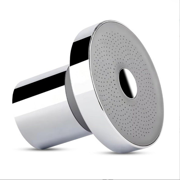 Round shower head faceplate with oval spray holes on chrome shower arm