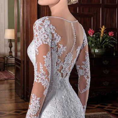 White lace mermaid wedding dress with open back and long illusion sleeve details