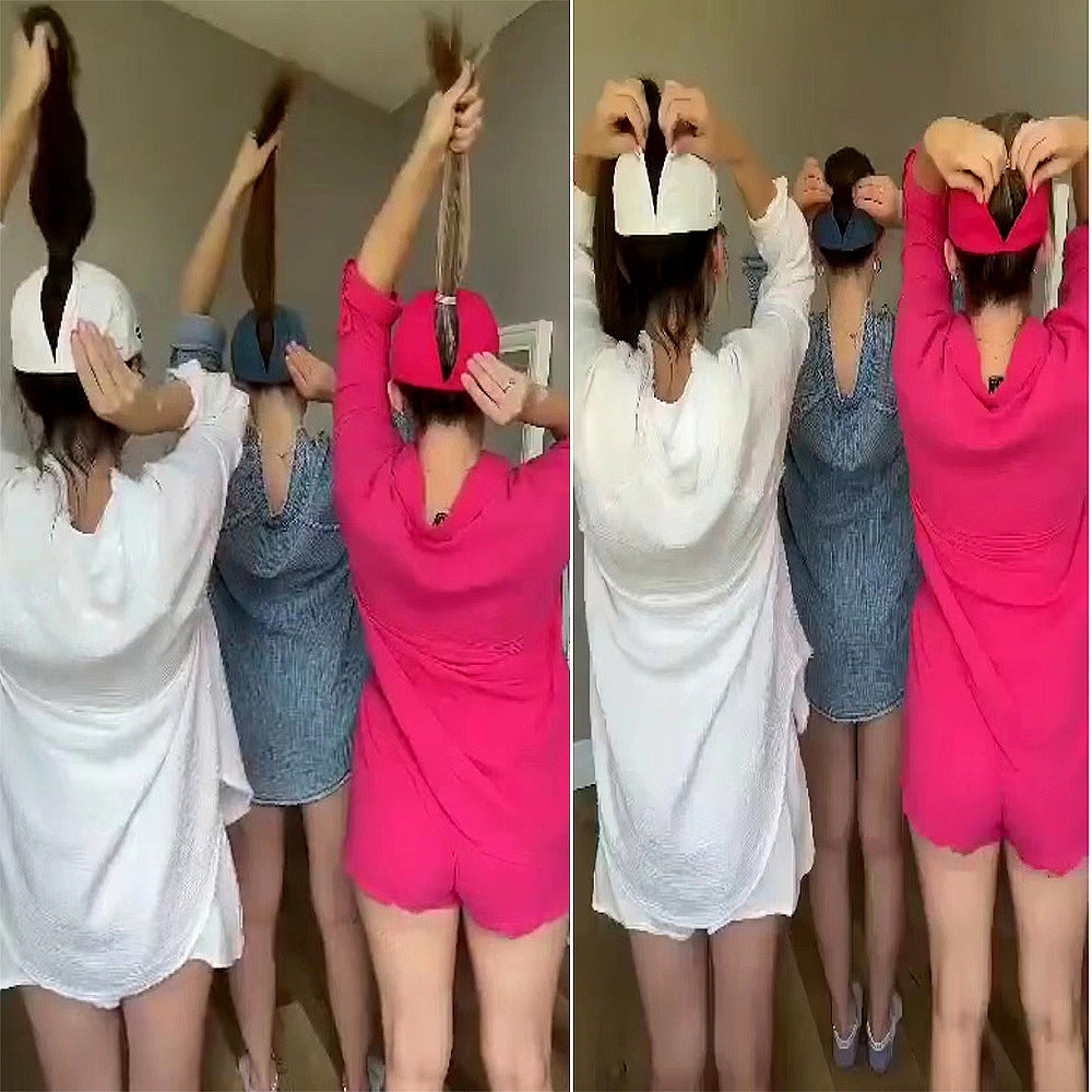 Pink ponytail baseball cap worn with hair pulled through the open back