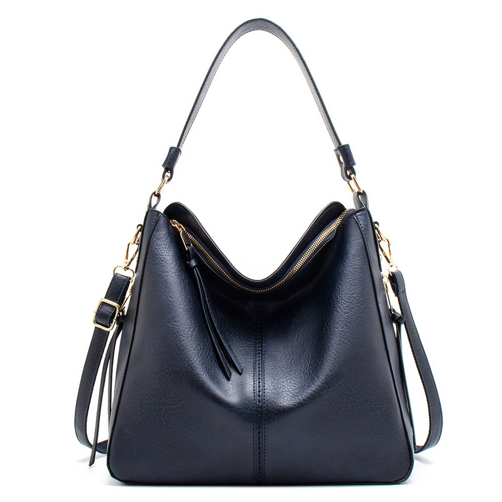 Dark blue PU leather hobo crossbody bag with gold hardware, zipper top, tassel pulls