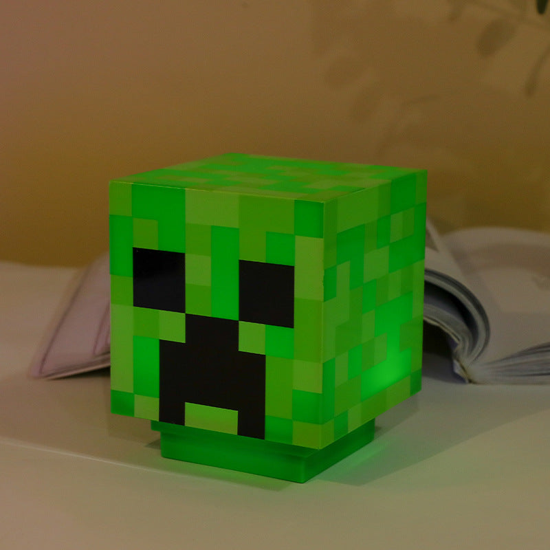 Minecraft LED torch night light, green glowing cube head on display stand