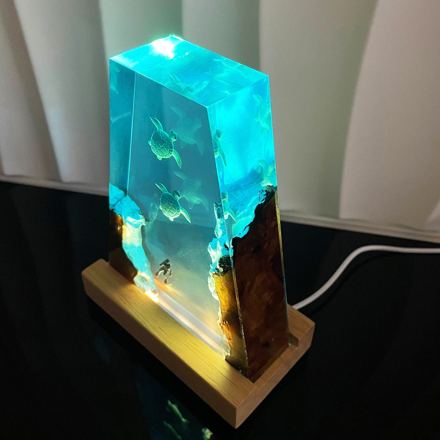 Wood night lamp with glowing blue resin display and sea turtles