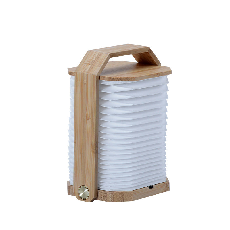 Wooden portable lamp with foldable handle and white pleated translucent shade