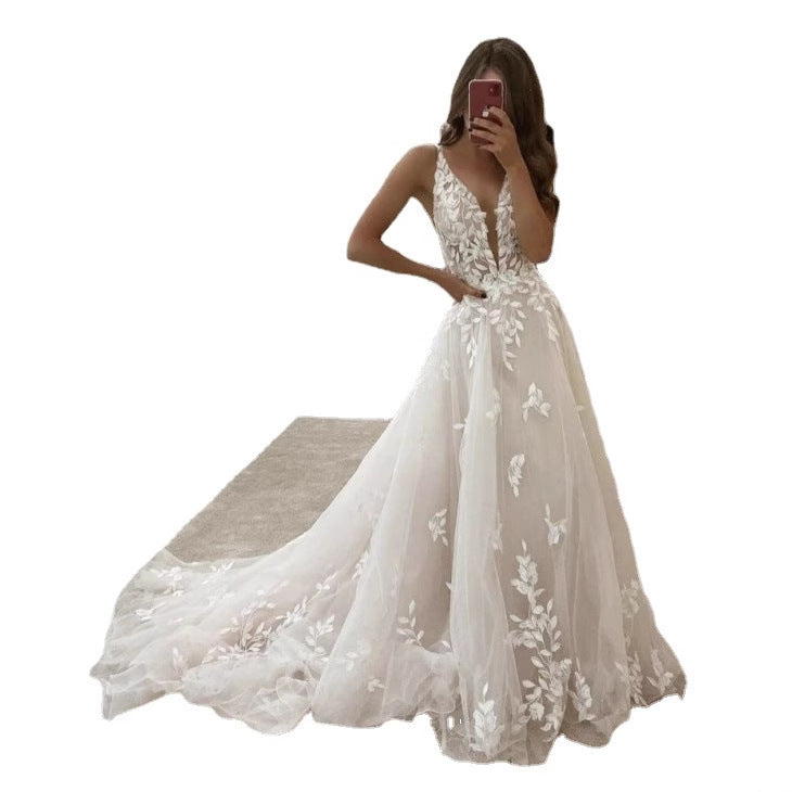 Ivory white wedding dress with floral lace, deep V-neck, and long train