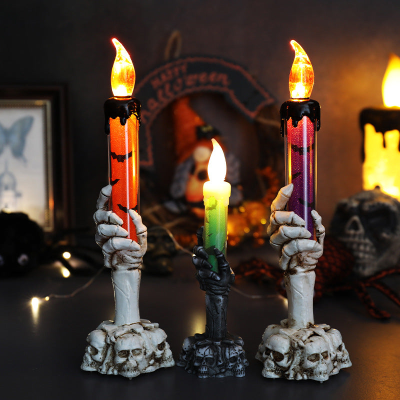Set of three LED ghost hand candles with skull bases and red and green glow flames