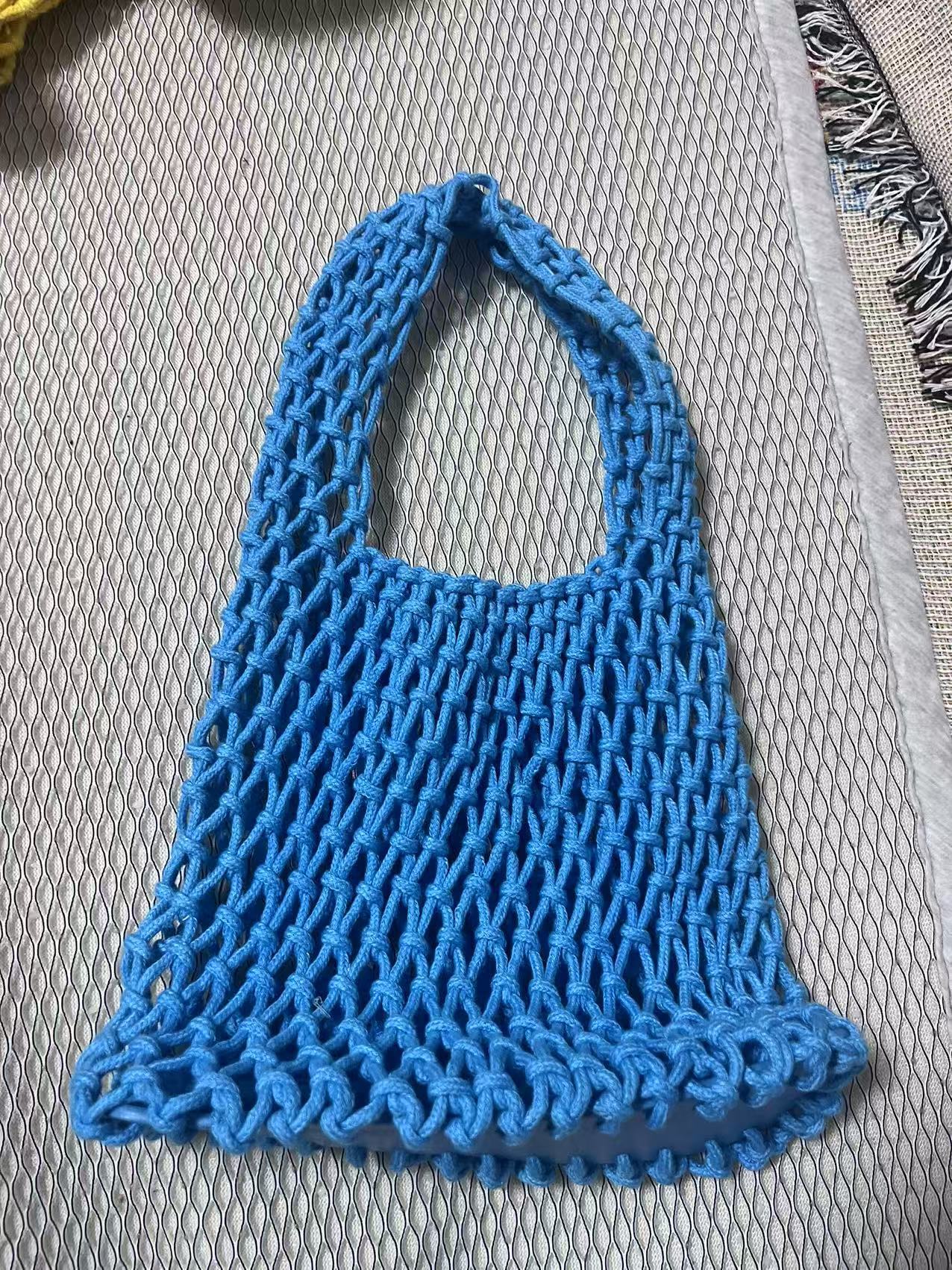 Bright blue cotton rope bucket bag with openwork net texture and scalloped bottom