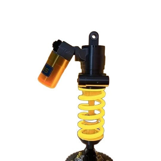 Suspension shock absorber desk lamp isolated view with yellow coiled spring and amber light