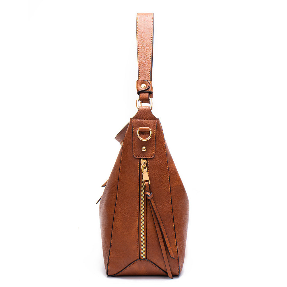 Brown PU leather crossbody bag with top strap and zip side tassel detail