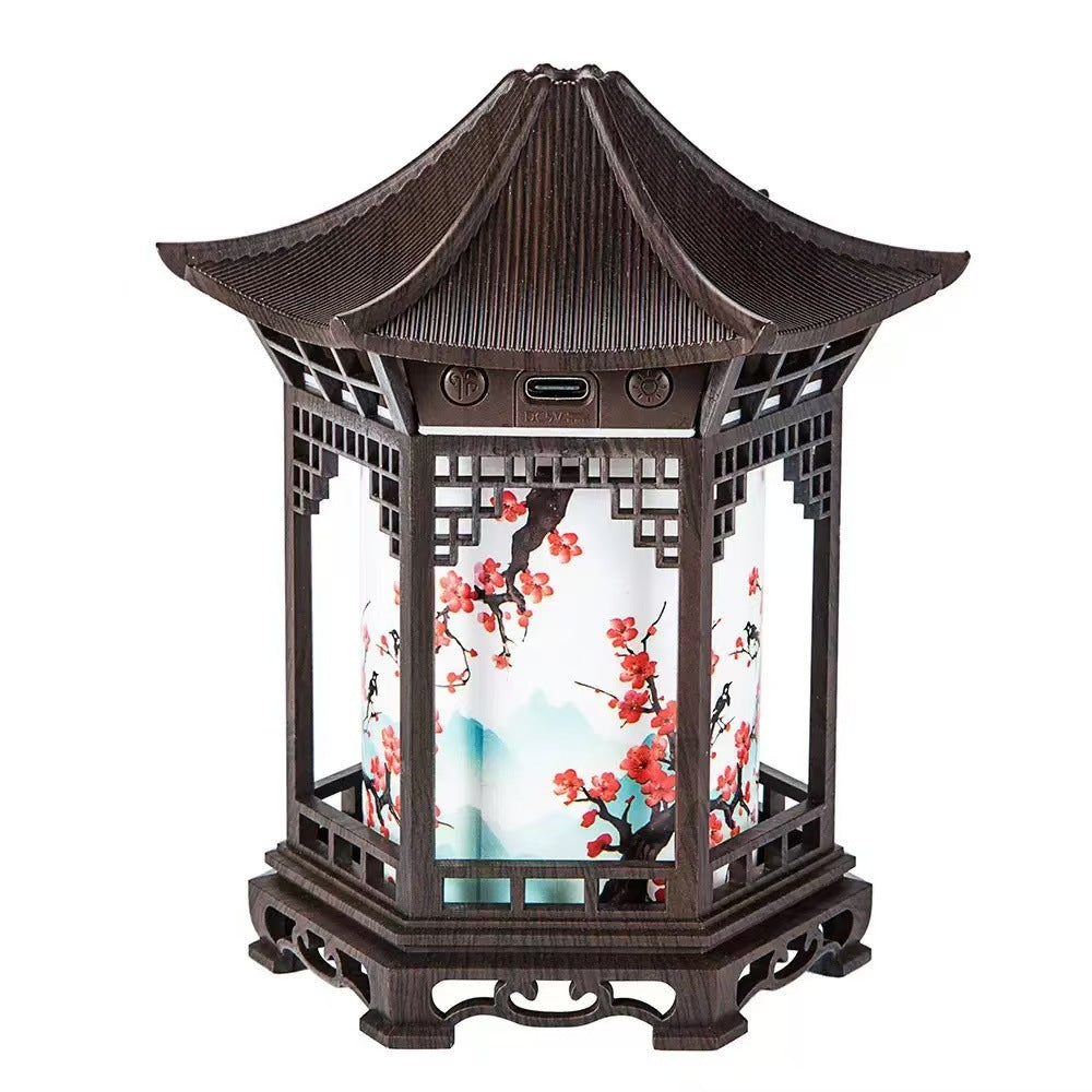 Humidifier night light lantern in dark wood with fine mist rising from top