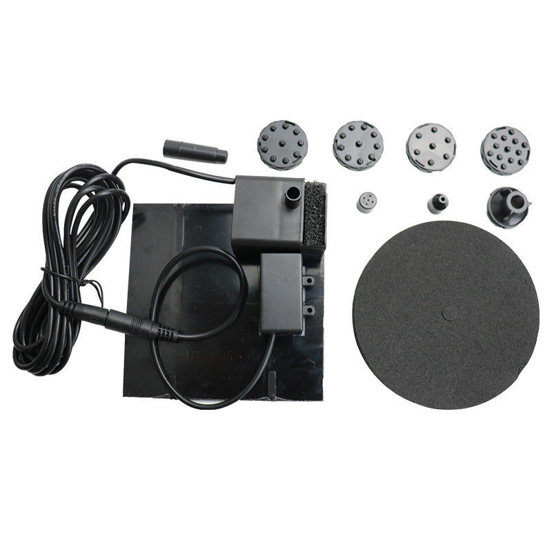 Solar fountain pump kit with pump unit, hoses, nozzle caps, and round base