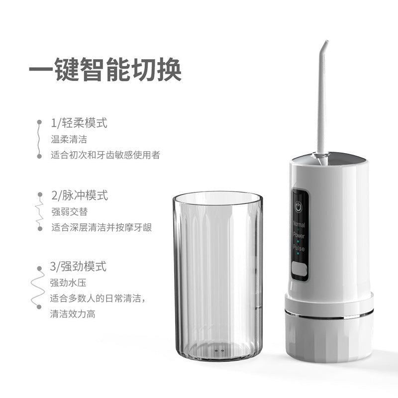 White portable water flosser with mode panel on handle and standing reservoir cup