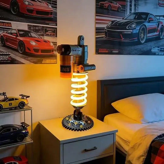 Suspension shock absorber desk lamp on nightstand with glowing yellow spring and round base