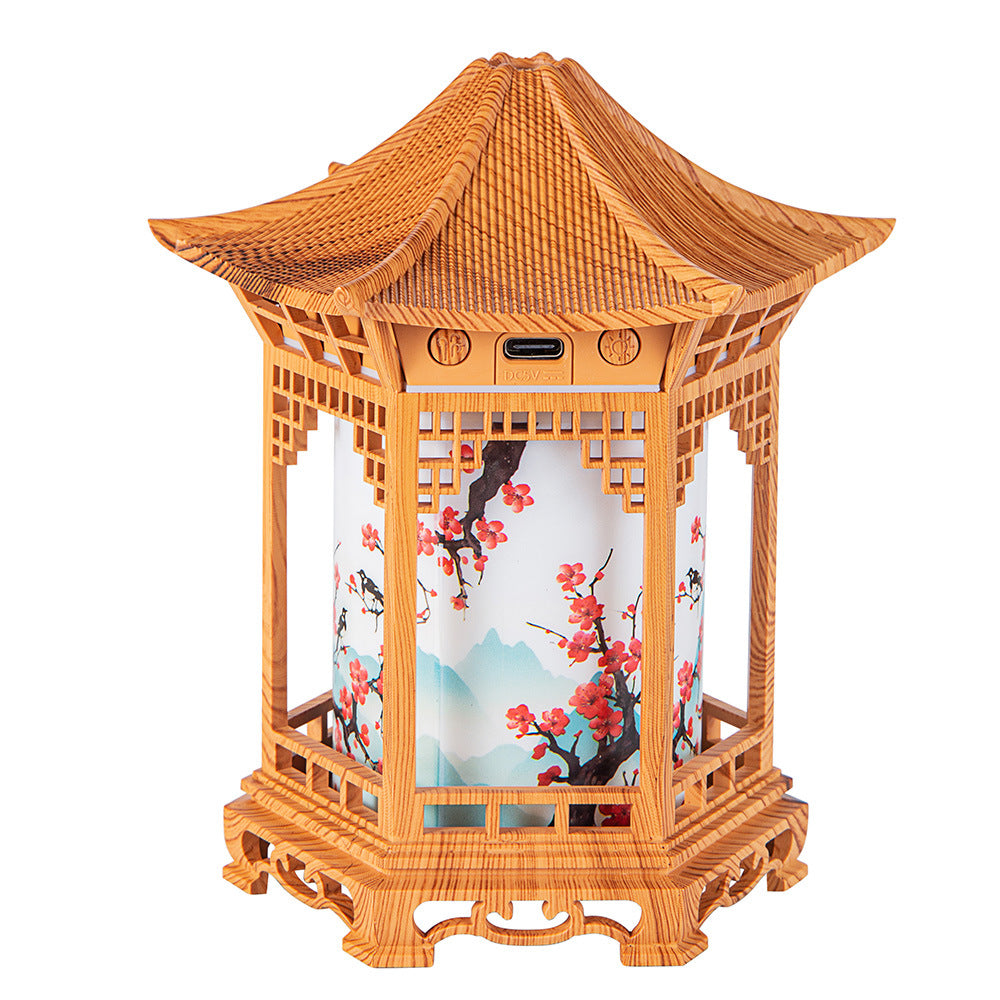 Humidifier night light lantern in light wood with glowing interior and visible mist