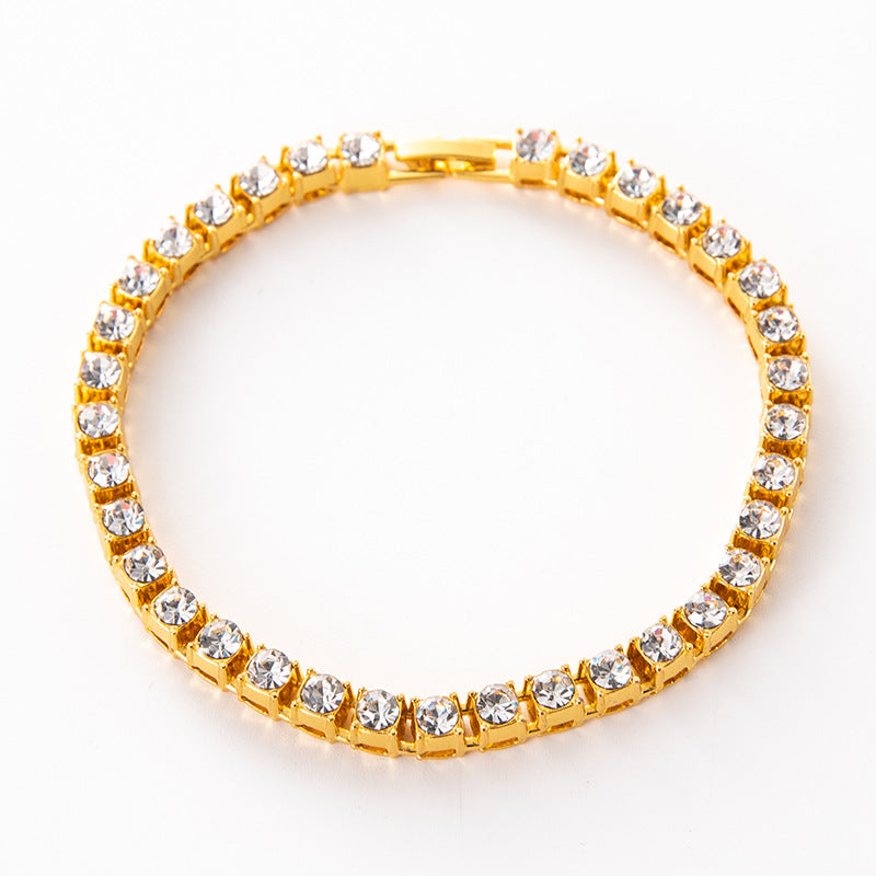 Gold diamond-cut tennis link bracelet with clear stone rows and hinged clasp