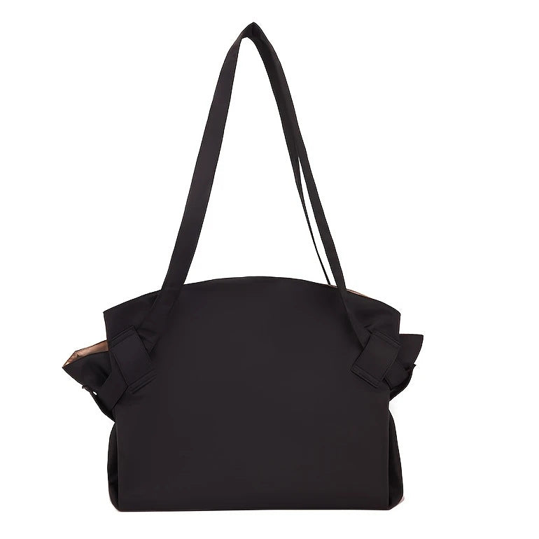 Black large-capacity duffel bag with short handles and folded side pocket details