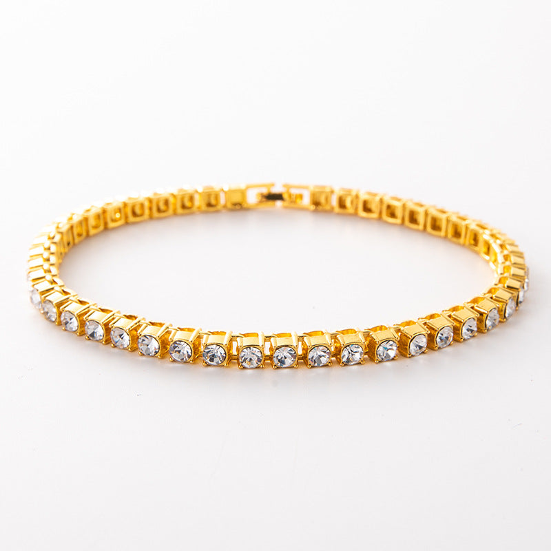 Gold diamond-cut Cuban link tennis bracelet with clear stones, link-detail close-up