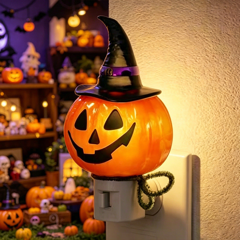 Witch hat jack-o’-lantern night light on wall plug with warm orange glow