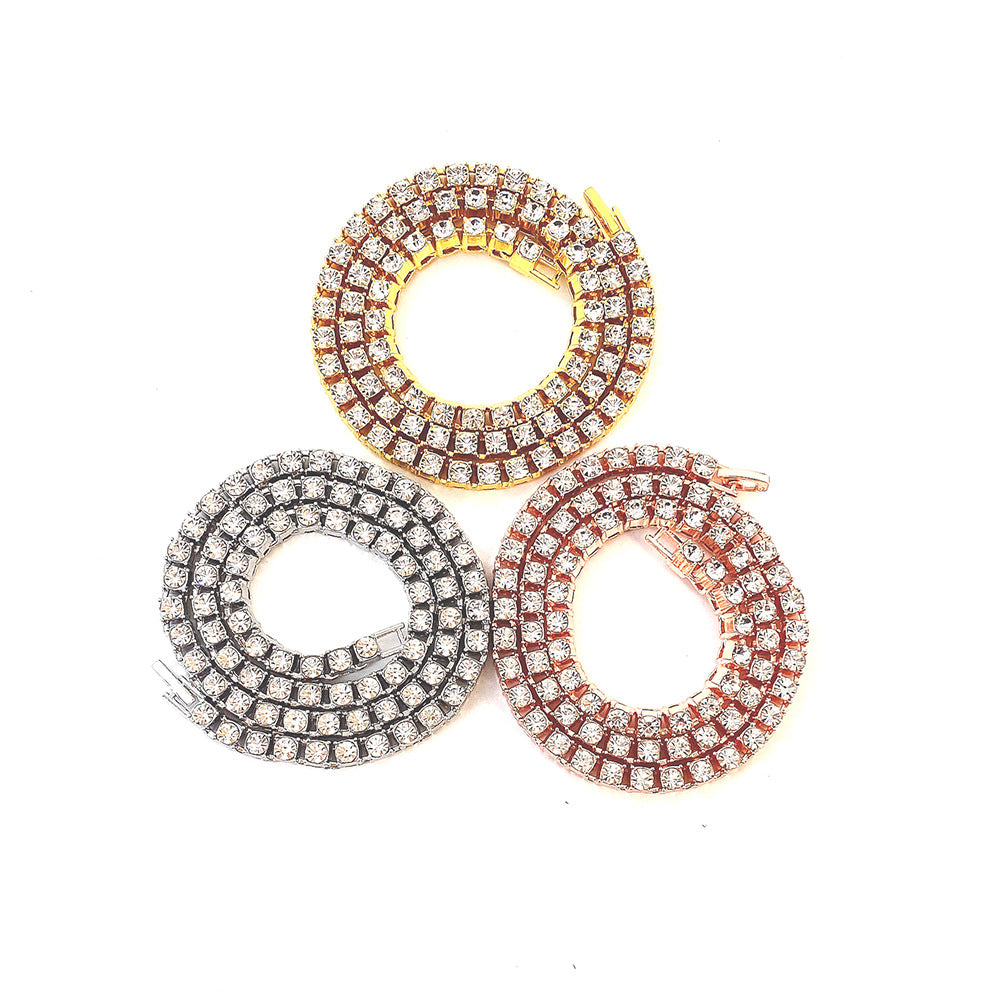 Diamond-cut tennis link chain trio in silver, gold, and rose-gold tones with clear stones