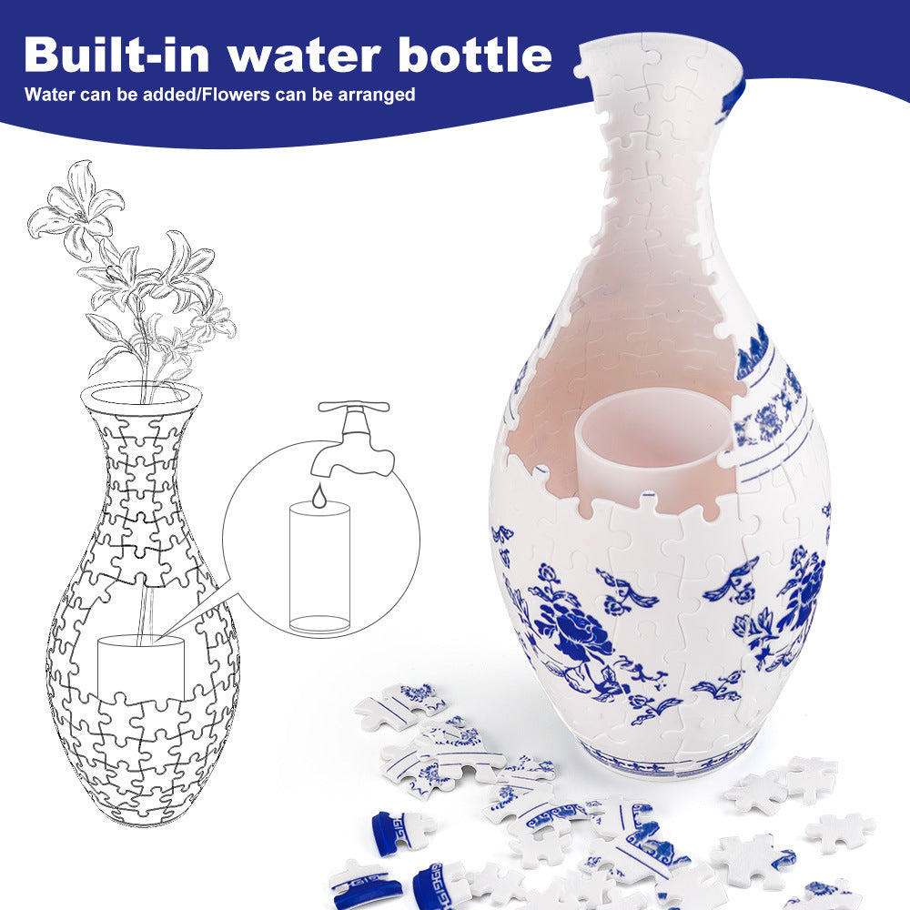 White and blue decorative puzzle vase with scattered jigsaw pieces around it.
