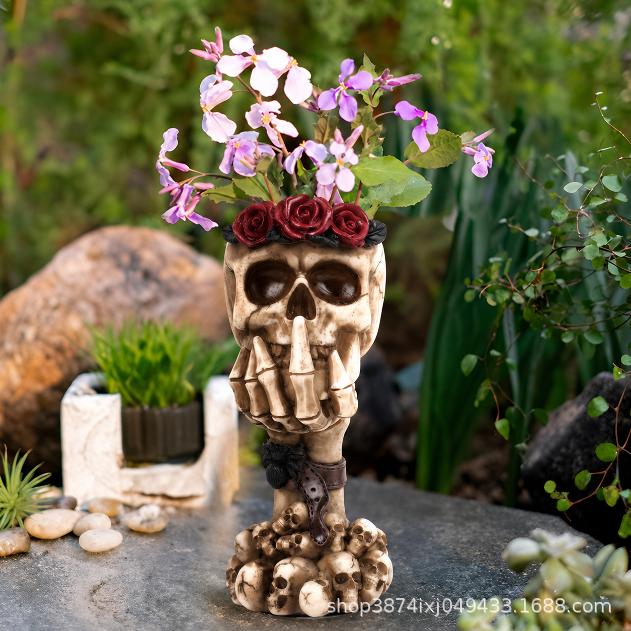Beige skull hand vase ornament with purple flowers and red roses on top, chain