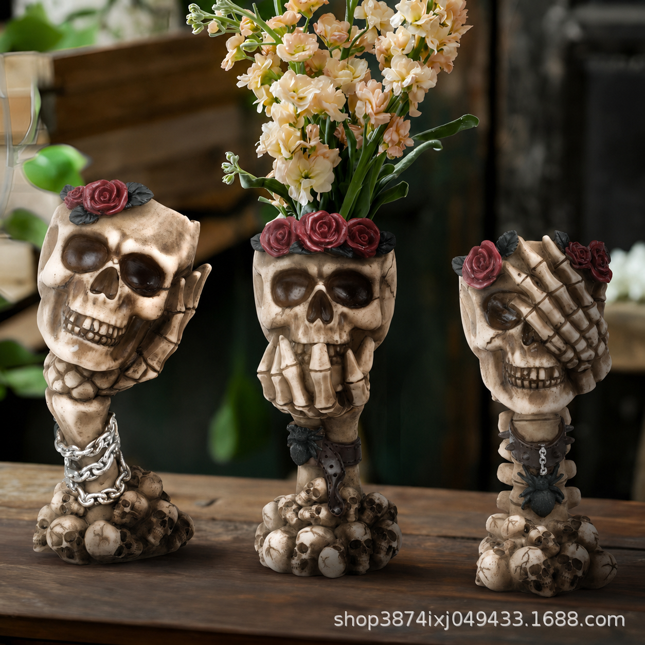Beige skull hand vase ornament with red roses, chain, and a small flower bouquet